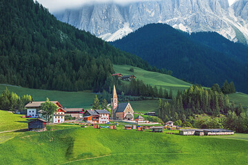 Small and famous alpine place  Santa Maddalena village with magical Dolomites mountains in background, Val di Funes valley, Trentino Alto Adige region, Italy