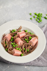 Cooked sausages pierced by noodles. Children menu, funny meal.