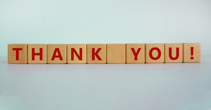Wooden cubes with the inscription 'thank you'. Beautiful white background, copy space. Concept.