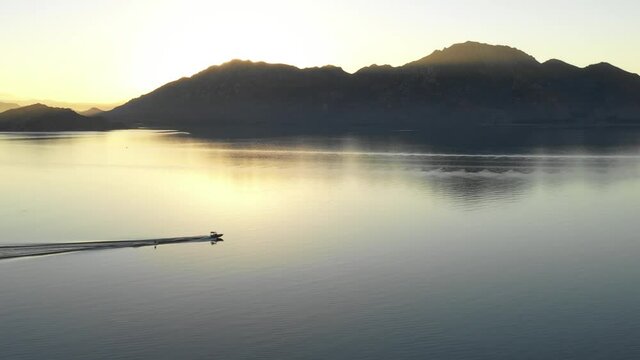 A water skier over a smooth lake #4