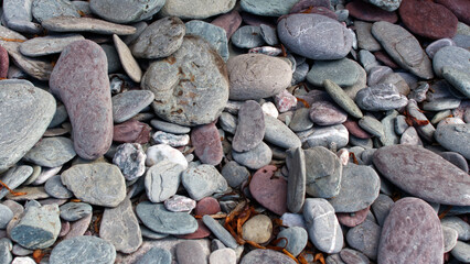 Pebbles at the beach balanced and fallen beautiful colours and textures