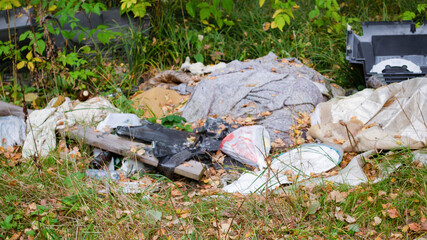 Garbage in the forest. Ecological problem. Plastic, glass, cans.