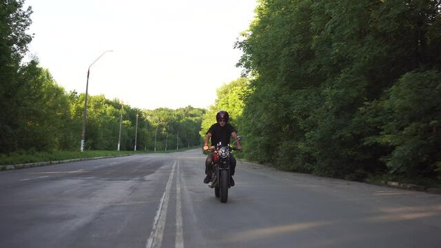 Motorcyclist riding fast on country road,cafe racer motorcycle adventure lifestyle