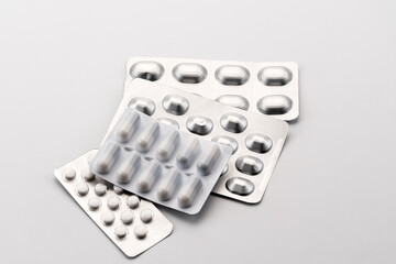 blisters of pharmaceutical medicines in capsules and pills for therapy on white background