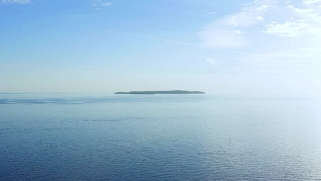 Aerial dolly shot backing away Susak island in Croatia during the morning.