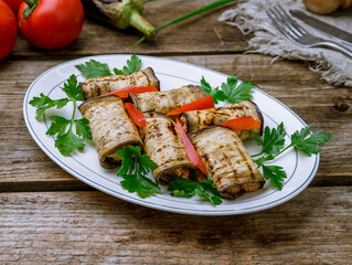 Eggplant rolls stuffed with nuts on old wooden table