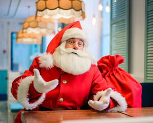 Friendly santa claus in a cafe.