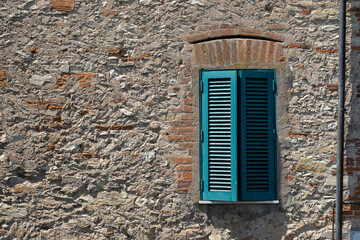 old wooden window on brown brick wall background, stone wall with little window