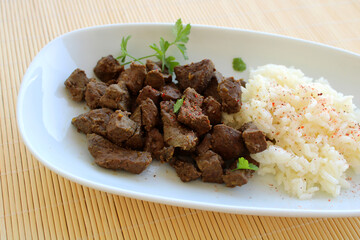 rice and cow liver with spice in a plate