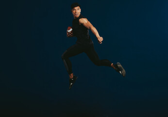 Fototapeta na wymiar American football player running with ball