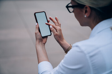 Anonymous lady watching photos on smartphone