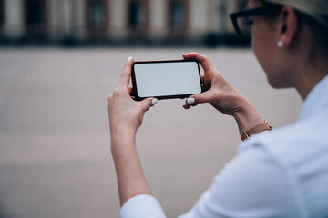 Crop female watching video on smartphone
