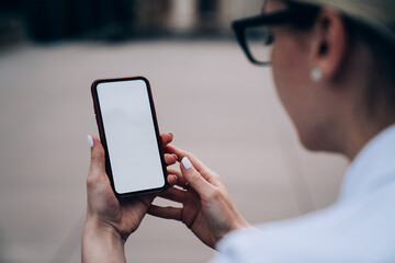 Crop woman browsing mobile phone