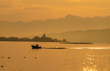 Sunset view of the Upper Zurich Lake (Obersee) and the historical wooden bridge (Holzsteg) between Hurden (Schwyz) and Rapperswil (St. Gallen), Switzerland