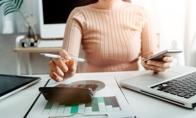 businesswoman hand using smart phone,mobile  payments online shopping,omni channel,digital tablet docking keyboard computer at office in sun light