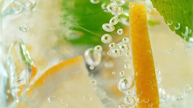 Macro Shot of Fizzy Soft Drink with Ice, Bubbles, Mint and Lemon. Phantom Flex 1000fps
