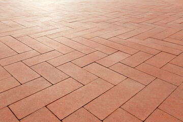 Long paving slabs of different sizes are laid like parquet.