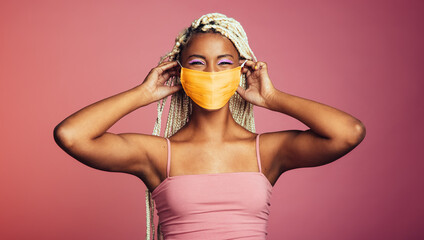 Smiling african woman wearing protective face mask
