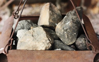 Iron stove with stones and soot macro 