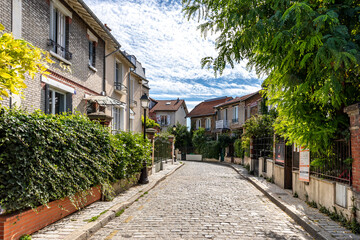 Fototapeta na wymiar Paris, France - September 9, 2020: Beautiful old house, like in the countryside, in the center of Paris, in the area called 