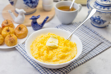 Delicious and healthy Breakfast with corn porridge and baked apples.