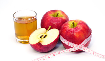 apple cider vinegar,apple and apple juice with tape measure on white background, healty food, drink for weight control in summer.
