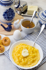 Delicious and healthy Breakfast with corn porridge and baked apples.