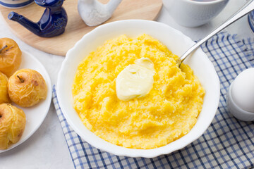 Delicious and healthy Breakfast with corn porridge and baked apples.