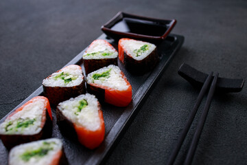 Seafood delicatessen salmon sushi rolls on plate