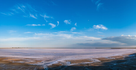 Sunset on the Genichesk pink extremely salty lake (colored by microalgae with crystalline salt depositions), Ukraine. High resolutin multishot panorama.