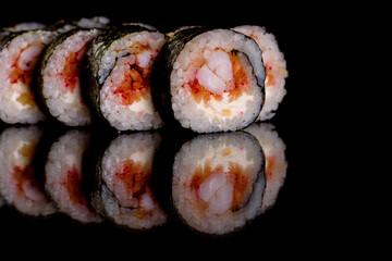 Fresh delicious beautiful sushi rolls on a dark background