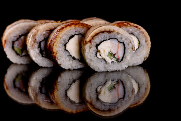 Fresh delicious beautiful sushi rolls on a dark background