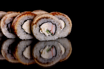 Fresh delicious beautiful sushi rolls on a dark background