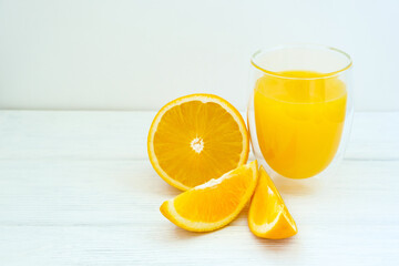 Oranges and orange juice on white wooden background