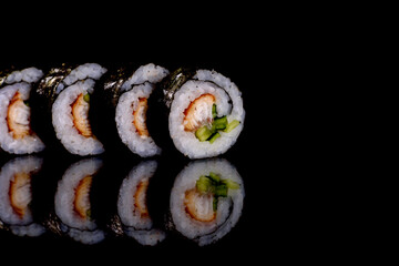 Fresh delicious beautiful sushi rolls on a dark background