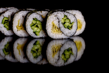 Fresh delicious beautiful sushi rolls on a dark background