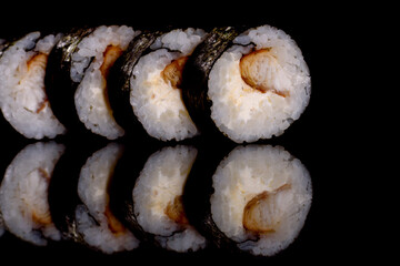 Fresh delicious beautiful sushi rolls on a dark background
