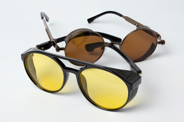 two sunglasses from the sun lie on a white background