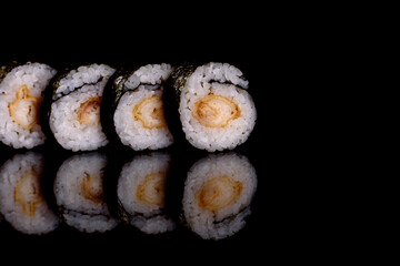 Fresh delicious beautiful sushi rolls on a dark background