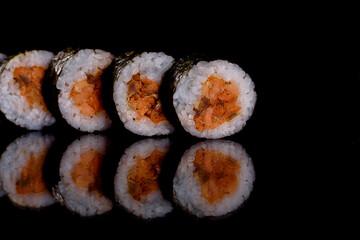 Fresh delicious beautiful sushi rolls on a dark background