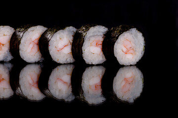 Fresh delicious beautiful sushi rolls on a dark background