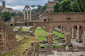 Fototapeta na wymiar Scenic view of ancient roman ruins in the Forum Romanum. Ruins of the Roman Forum: the temple of Castor and Pollux and the Church of Santa Maria Antiqua, Rome, Italy