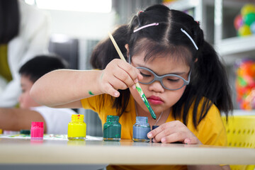 Disabled kids classroom, children having fun during study at school, kids learning together,...