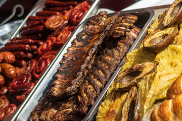 Healthy street food to go - sausages, poultry and meat. Delicious food cooked over an open fire, which is offered at a street food fair, event, festival.