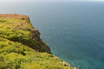 Obraz premium Hiking along the coast, by the waterfalls and in the green levadas of Madeira Island in Portugal