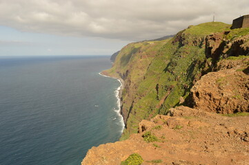Fototapeta na wymiar Hiking along the coast, by the waterfalls and in the green levadas of Madeira Island in Portugal