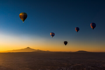 Hot air balloons  at sunrise in  Goreme National Park, Cappadocia, Turkey.