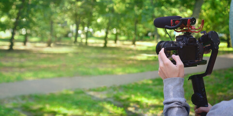 Ready for blogging. Man&rsquo;s hands holding camera ready for blog recording in a city square. 