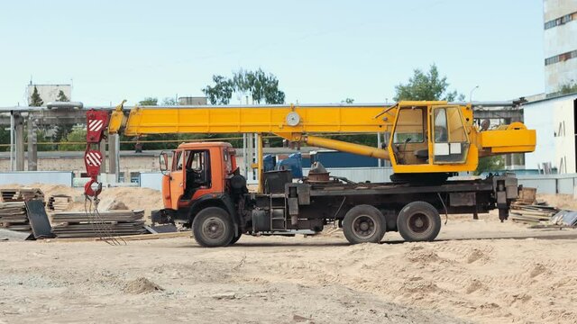 A machine with lifting crane parked on the construction site