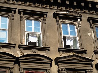 White shirts hanging in the windows of an old ornate historical brown grey building in Budapest downtown, Hungary in a sunny autumnal September day